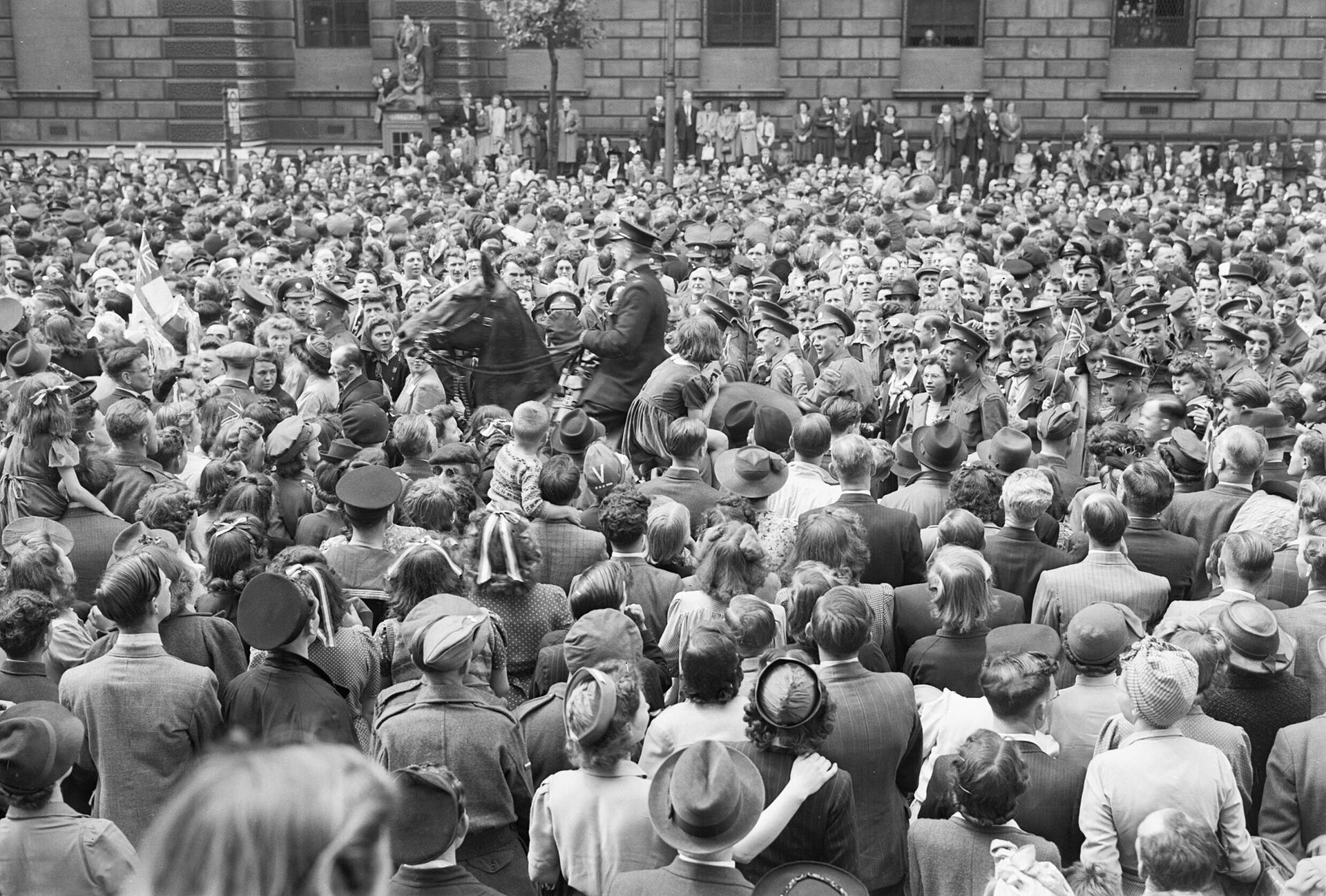 Crowds in Whitehall, London, celebrating Victory in Europe Day on 8 May 1945